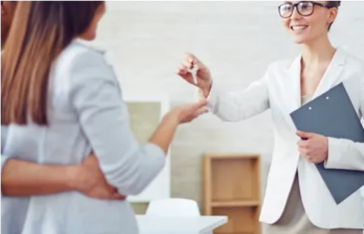 Broker giving keys to owners