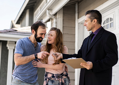 Broker giving keys to property owners