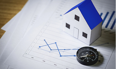 house and compass on table