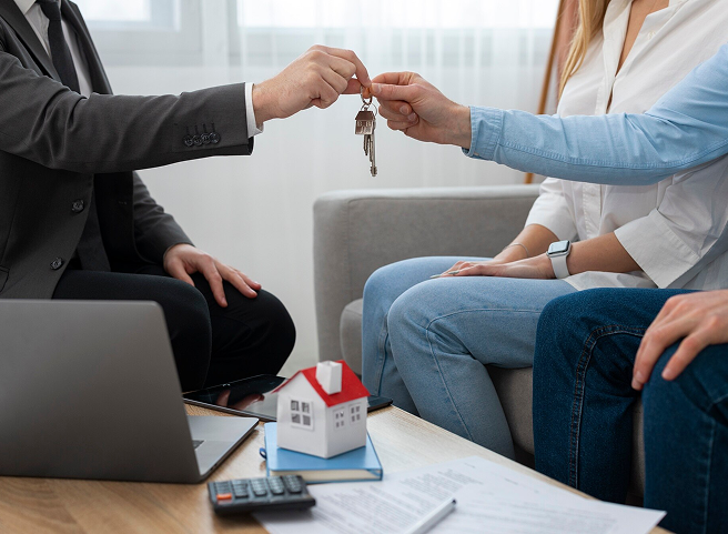 Person giving property keys to house owners