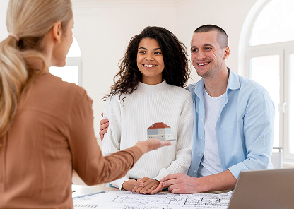 Happy people, real estate agent holding a small house model